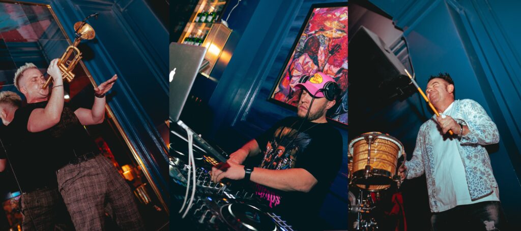 Picture Depicts DJ Playing on sonsole, Saxphonist and drummer playing and enjoying.